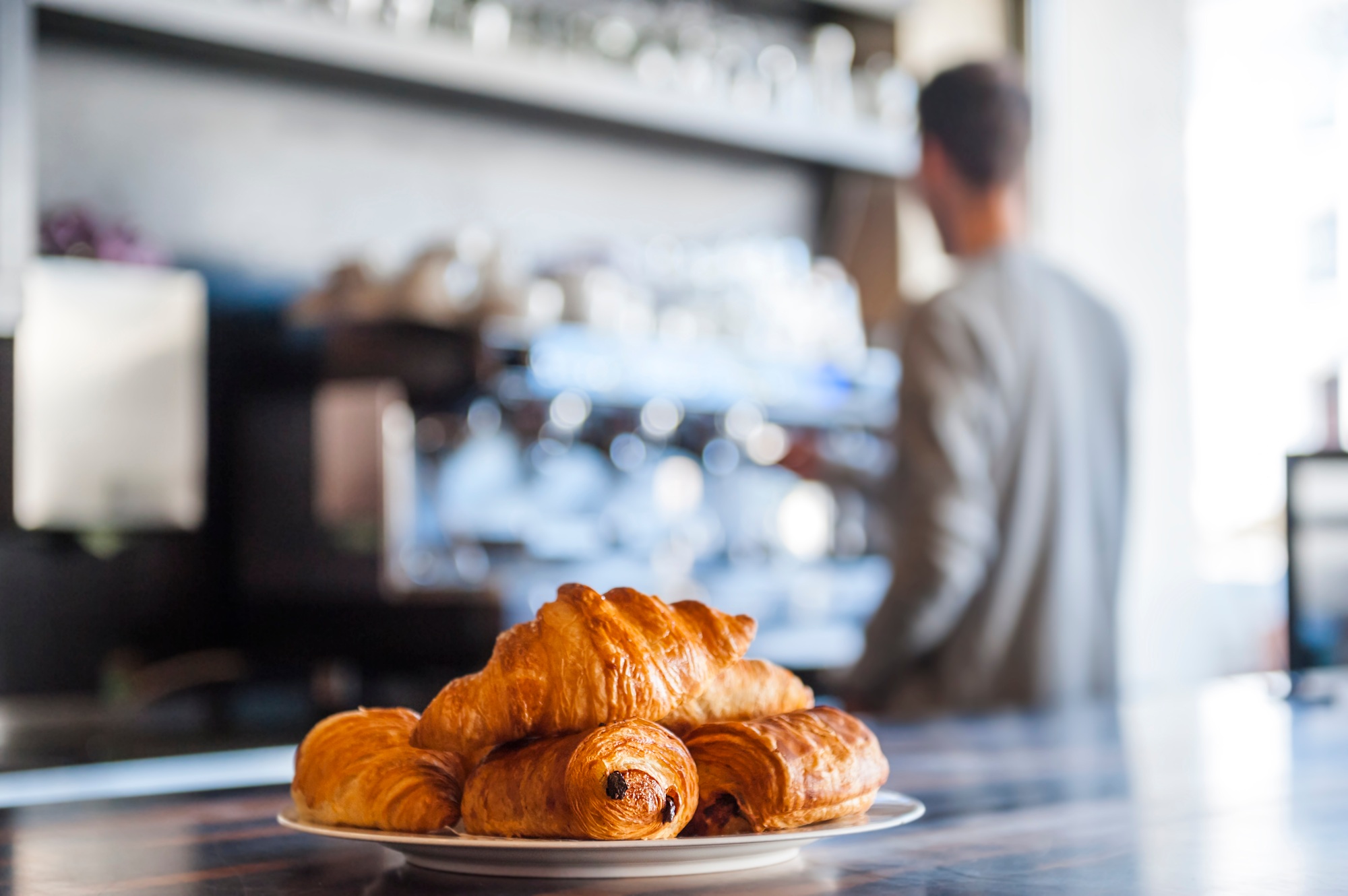 Croissants on plate on counter of a cafe